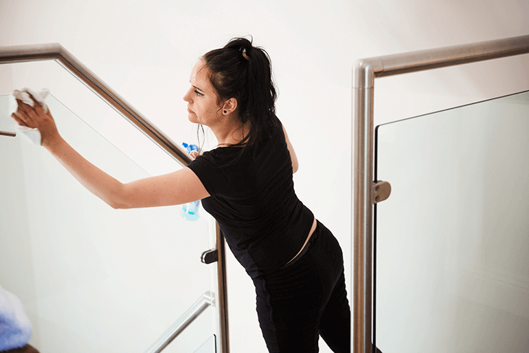 images of a business manager sanitizing a railing