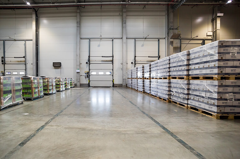 image of a clean warehouse floor and clutter-free environment with neatly stacked pallets.