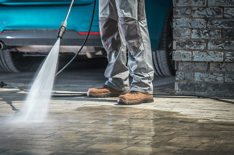 removing grease from pavement with high pressure washing