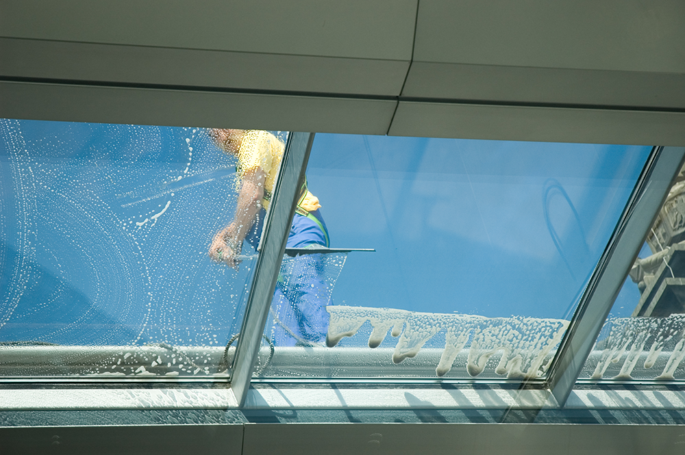 high up and hard to reach window being cleaned by professionals